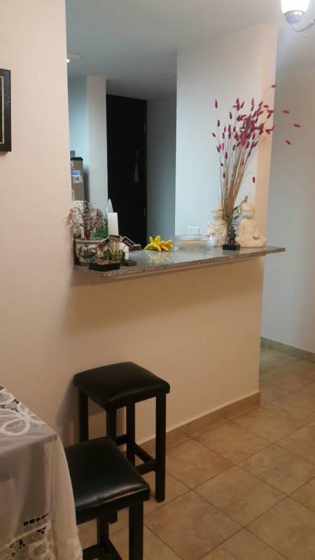 Kitchen with granite counters and wood cabinets in PH Cosmopolitan Towers Panama City