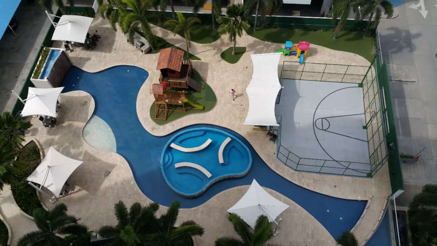 Aerial view of amenities deck with swimming pool, playground, Jacuzzi PH Cosmopolitan Towers Panama