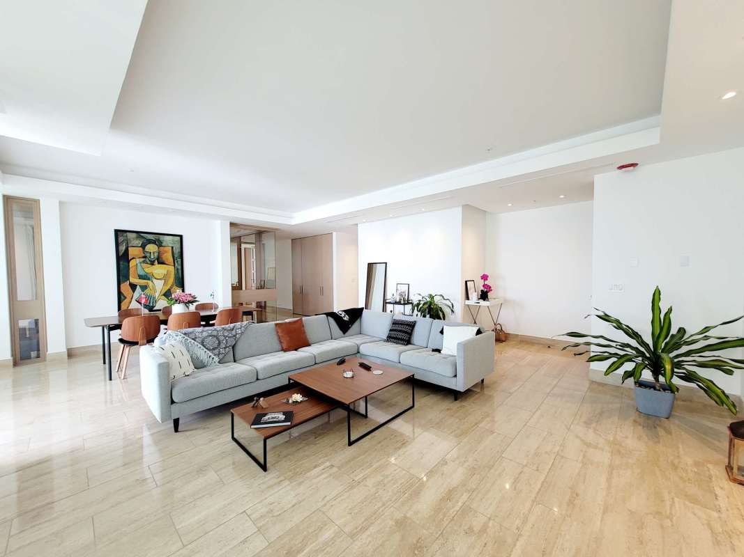 Spacious kitchen with granite countertops, white cabinetry and stainless appliances PH Aria Costa del Este