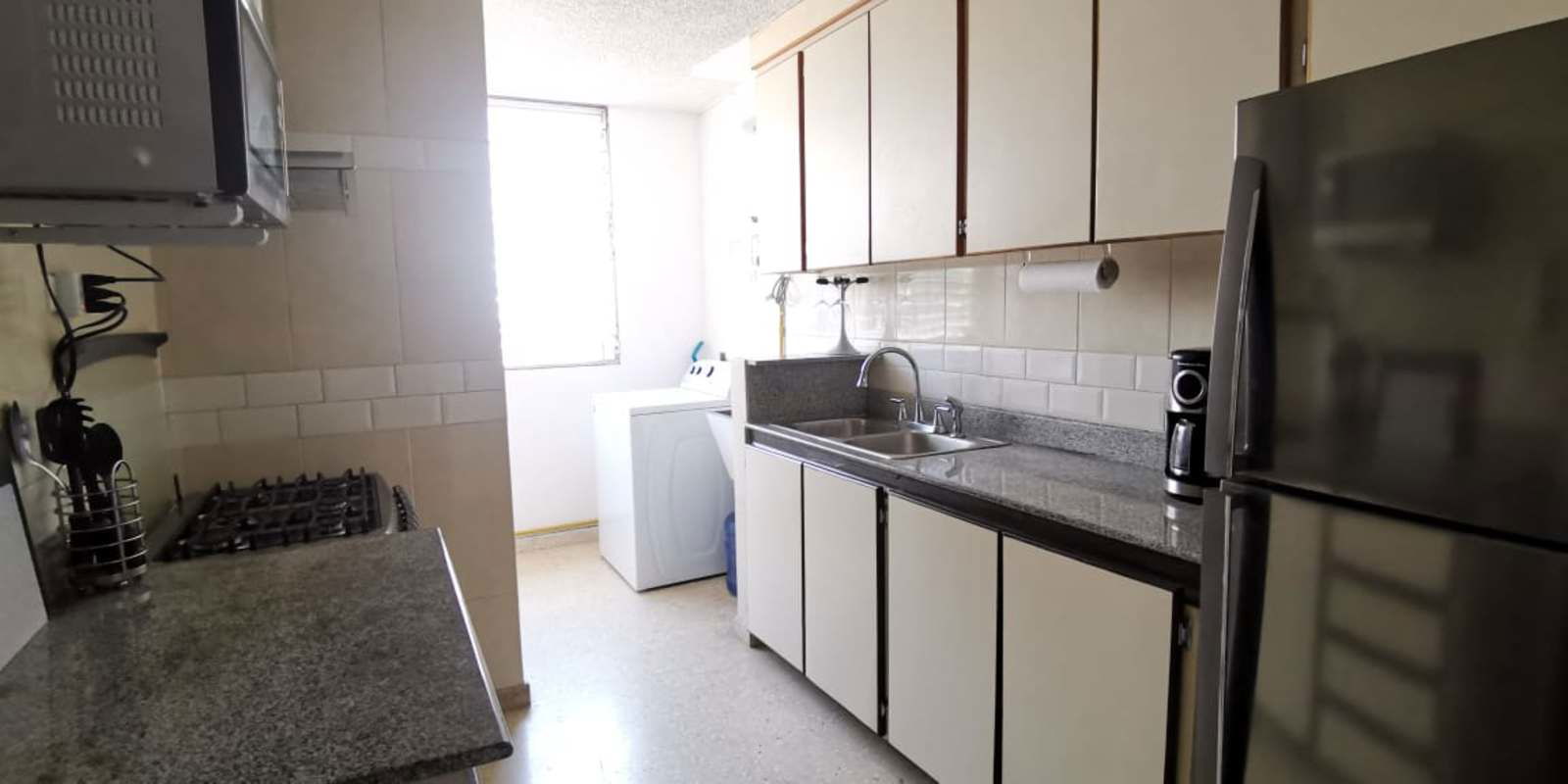 Compact granite kitchen with stove microwave PH Aida San Francisco Panama