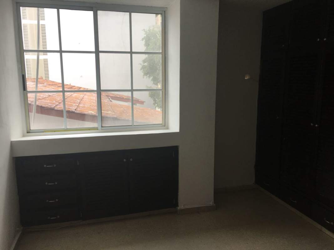 Bedroom with built-in cabinets and large window PH Aida San Francisco Panama City