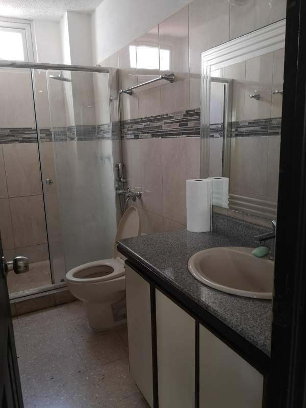 Interior hallway with white walls leading to bedrooms in PH Aida Panama City