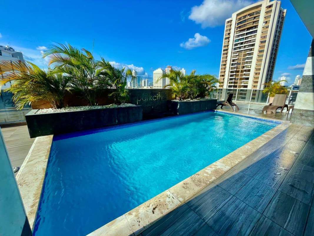 Expansive rooftop pool and lounge with panoramic city skyline PH Park City