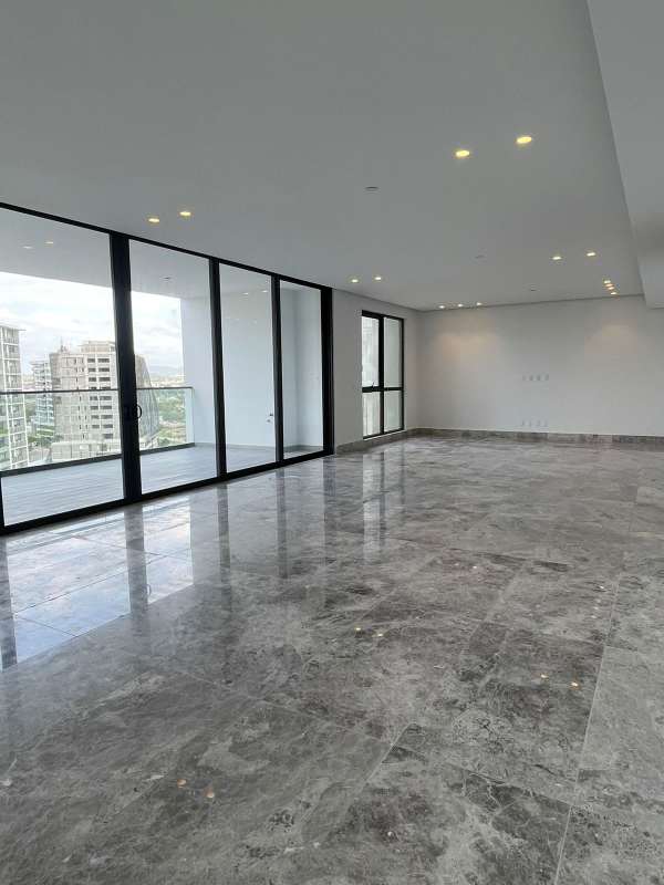 Gourmet kitchen with marble island and large windows at Empire Residences Santa Maria Panama City