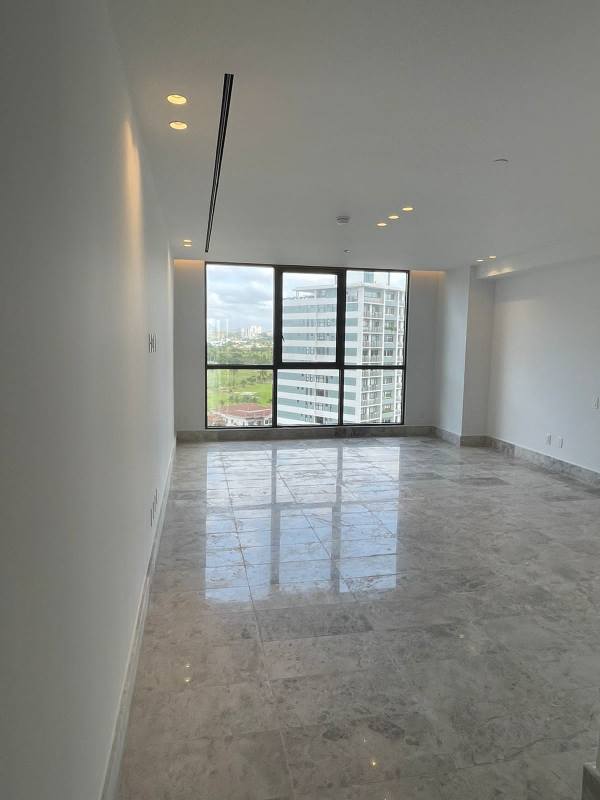 Bedroom with large windows offering city view and marble floors in Empire Residences Santa Maria Panama