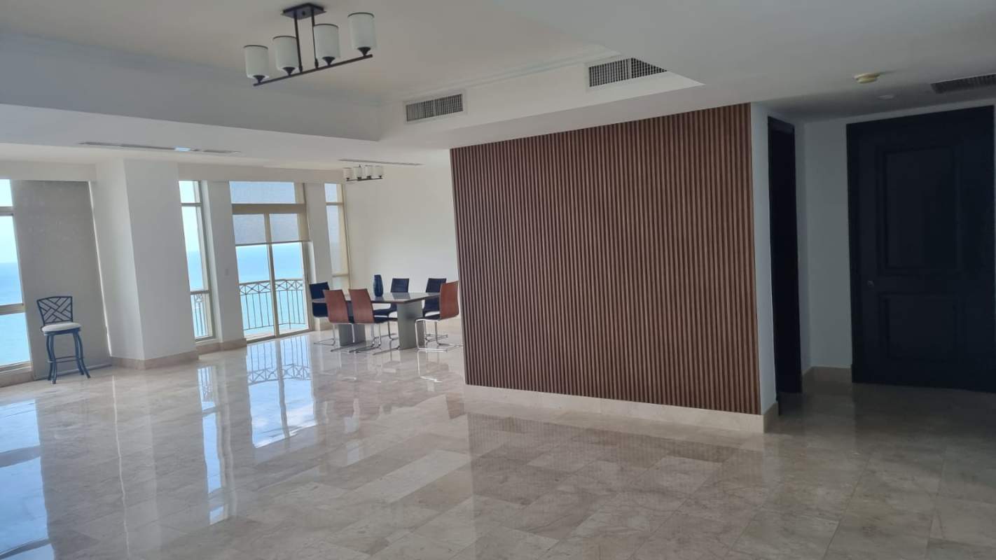 Open-concept living dining room with marble floor and ocean view at PH Pacific Point Punta Pacífica