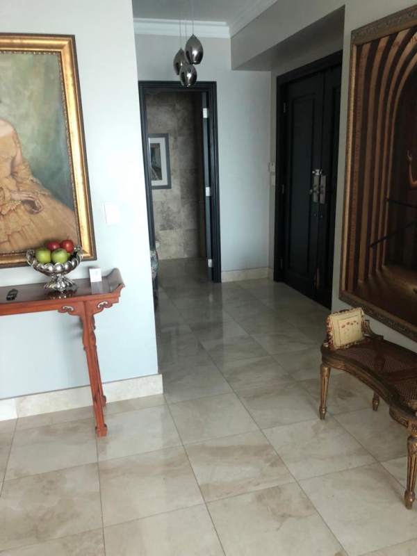 Luxury apartment entry hall with marble flooring and art decor in Ocean Two Panama