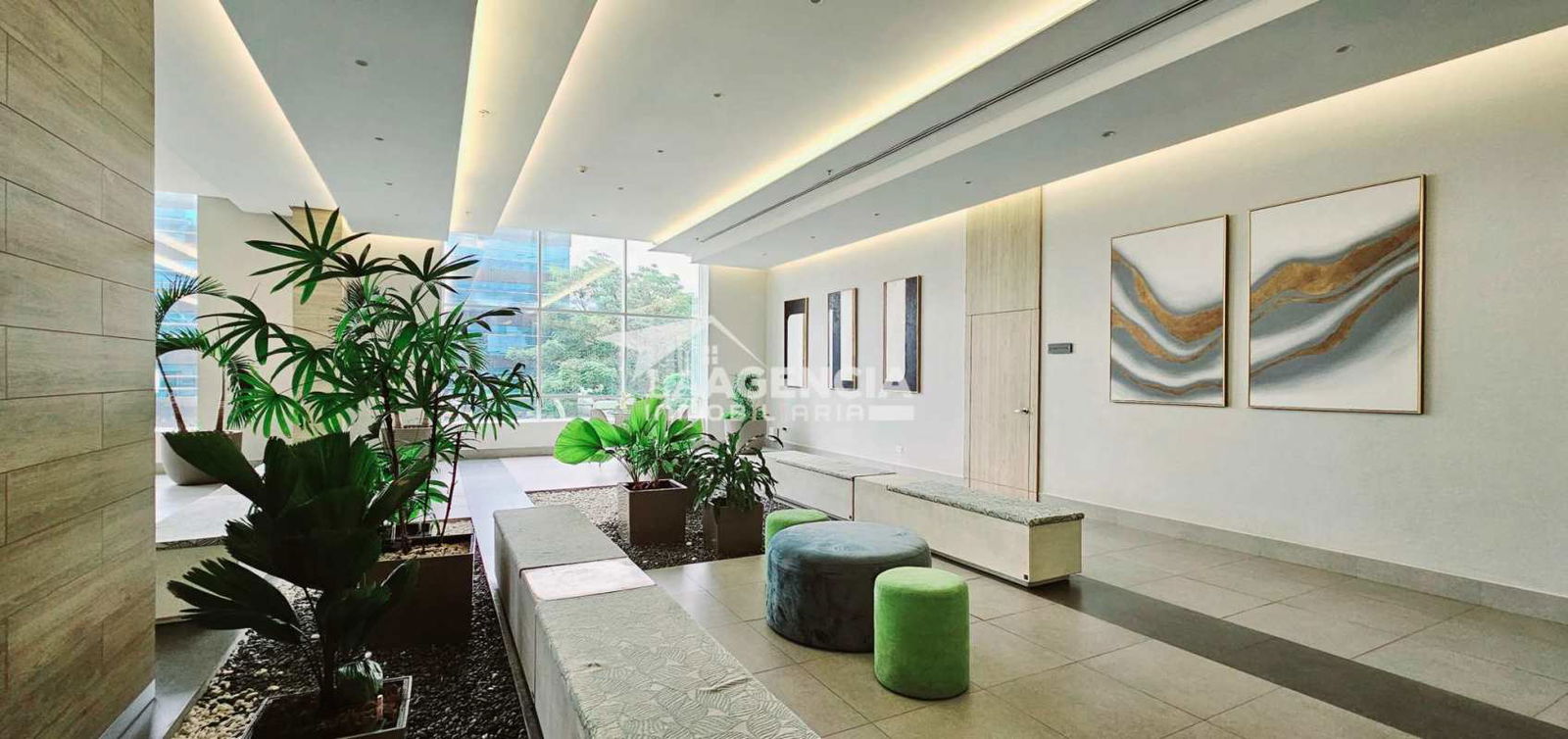 Contemporary lobby with indoor plants, seating and bright design at PH Vivendi Green Edison Park Panama City