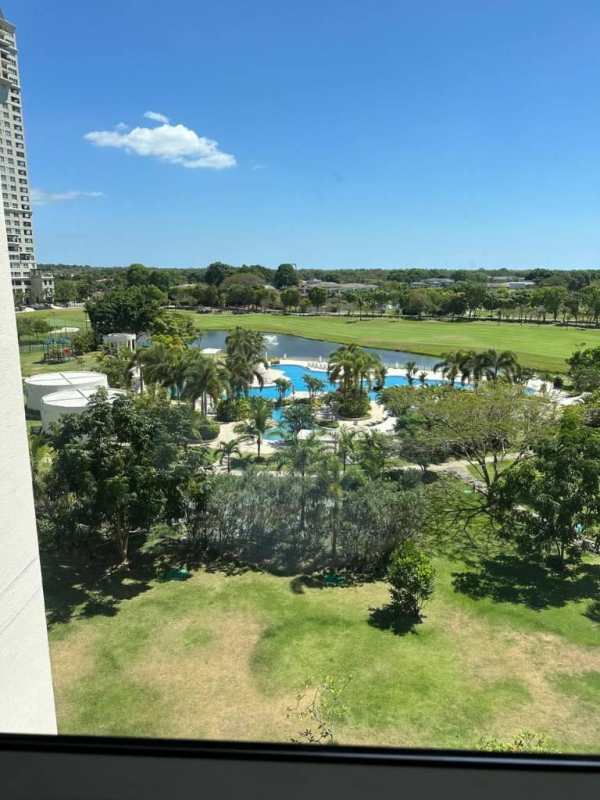 Modern kitchen with white cabinetry, island, granite countertops luxury apartment Santa María
