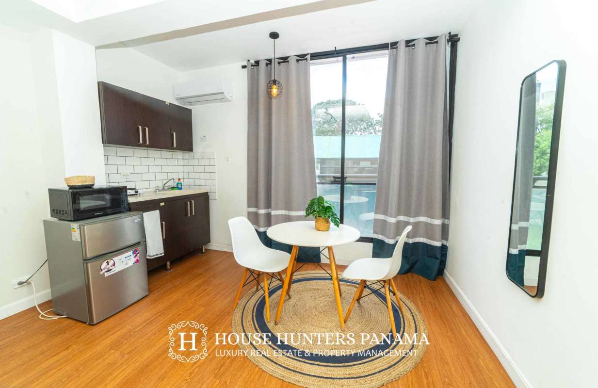 Furnished studio apartment with kitchenette and bed in Bella Vista Panama City rental building