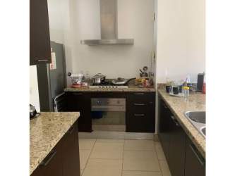 Spacious bedroom with wood floor and large window in PH Soleo Panama Pacifico condo