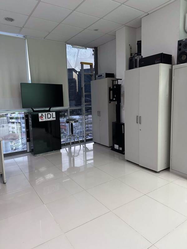 Private enclosed office inside PH Brazil 405 with glass walls, furniture and bright lighting