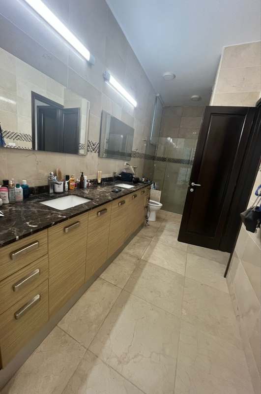 Marble bathroom with glass shower enclosure, modern fixtures in PH Venetian Tower Panama