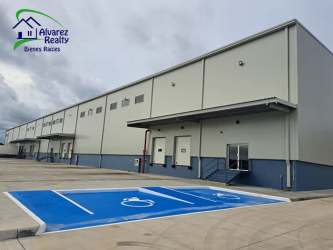 Industrial warehouse facility featuring multiple bays and parking area David Panama