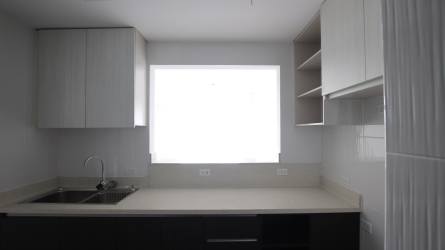 Modern bathroom with glass shower, large mirror and accent wall in Tucan Country Club Panama