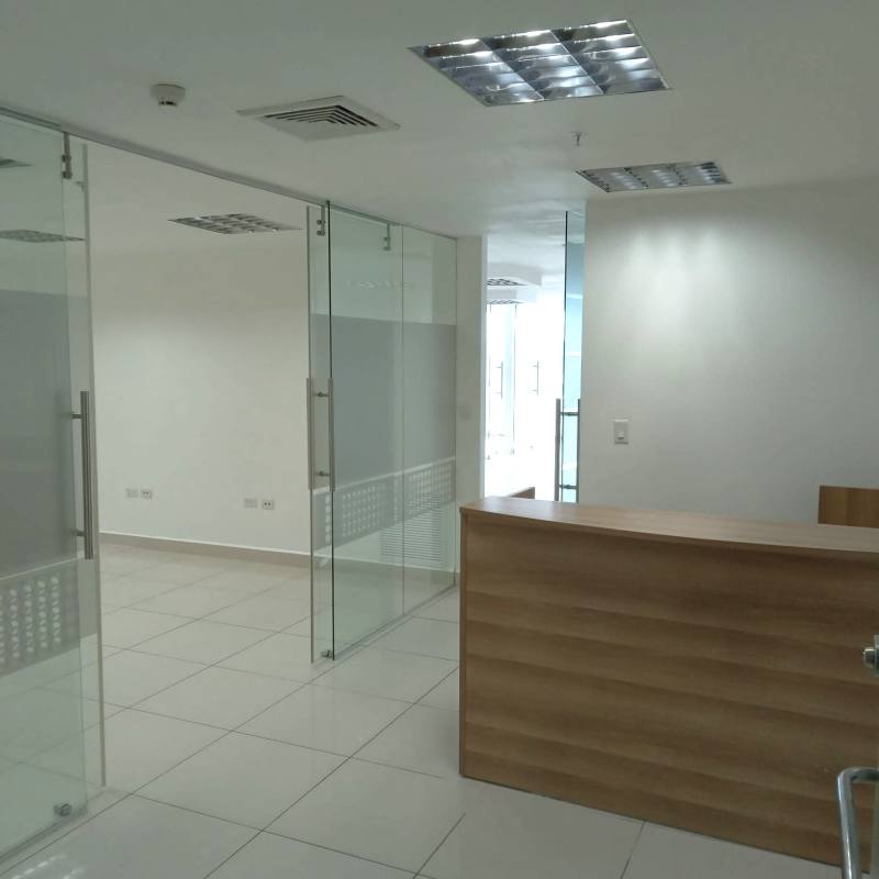 Bright corner office with floor-to-ceiling glass walls and ocean views at Oceanía Business Plaza Panama