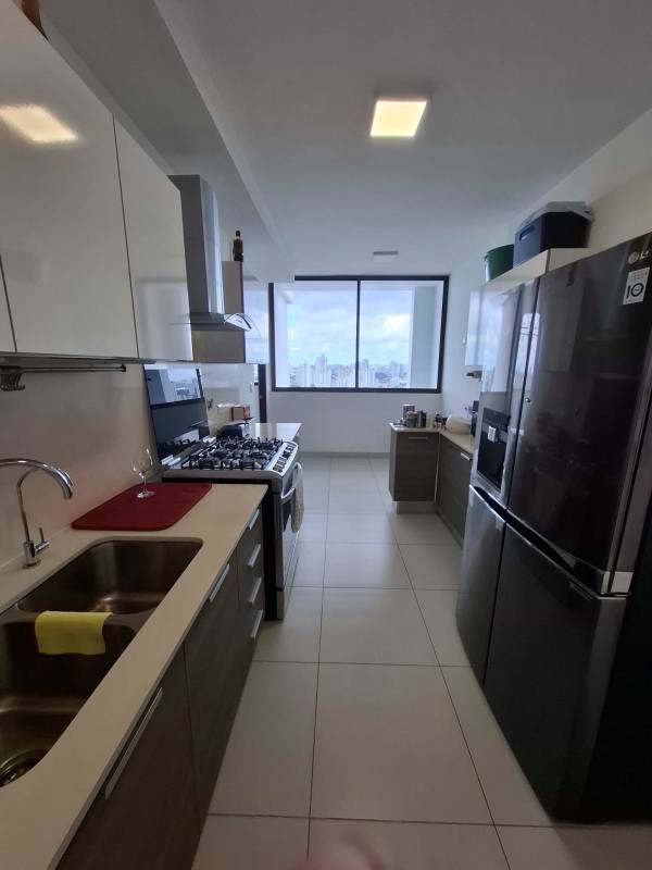 Bathroom double sink marble counter, large mirror, glass shower in Coco del Mar condo