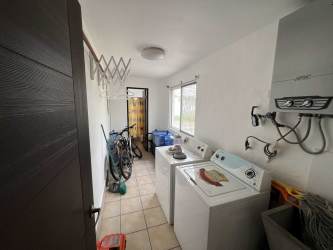 Covered terrace with arched columns, tile floors, garden view in Vista Mar Golf Beach Resort Panama