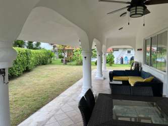 Covered patio with arches overlooking garden at Vista Mar Golf Resort Beach House Panama