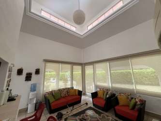 Contemporary open plan living dining with high ceilings, bright colors, and garden views at Vista Mar Beach House Panama