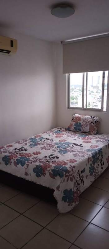 Bedroom with floral bedding city view window AC unit PH Vista Tower near Metro Panama