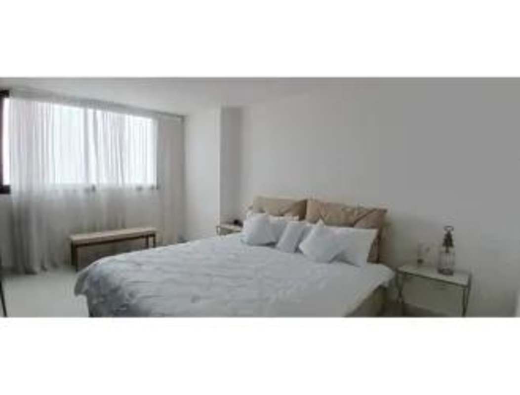 Bright bedroom with large window upholstered bed PH Carreras Tower Panama