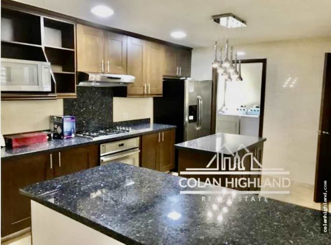 Fully equipped kitchen with island granite countertops stainless appliances in Tucan Country Club Panama