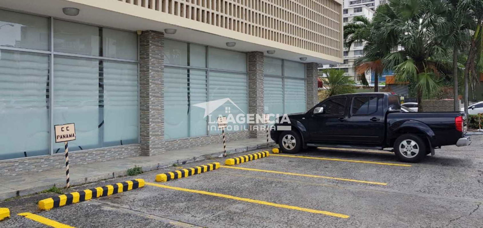 Commercial building exterior with glass facade, visitor parking CC Panama Tower Panama City