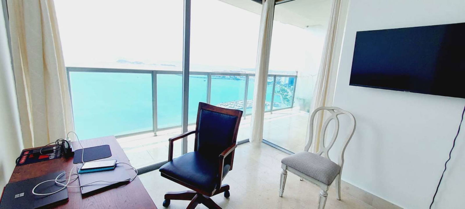 Spacious living room with sliding glass to ocean balcony PH Yoo Panama