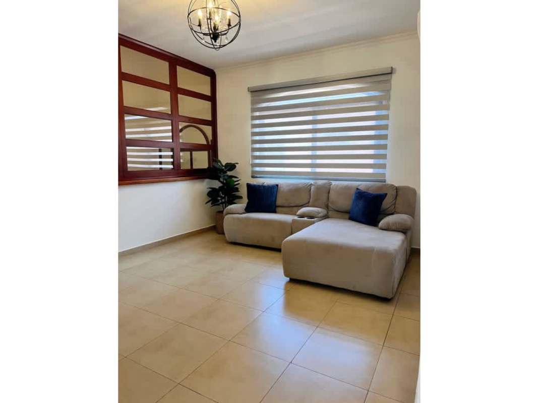 Bright living area with large windows, tile floors, minimal furnishing in Costa Sur
