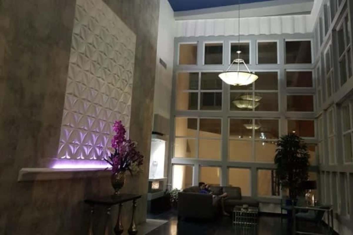 Panoramic rooftop with lounge chairs, night lighting city views PH Vivendi Towers