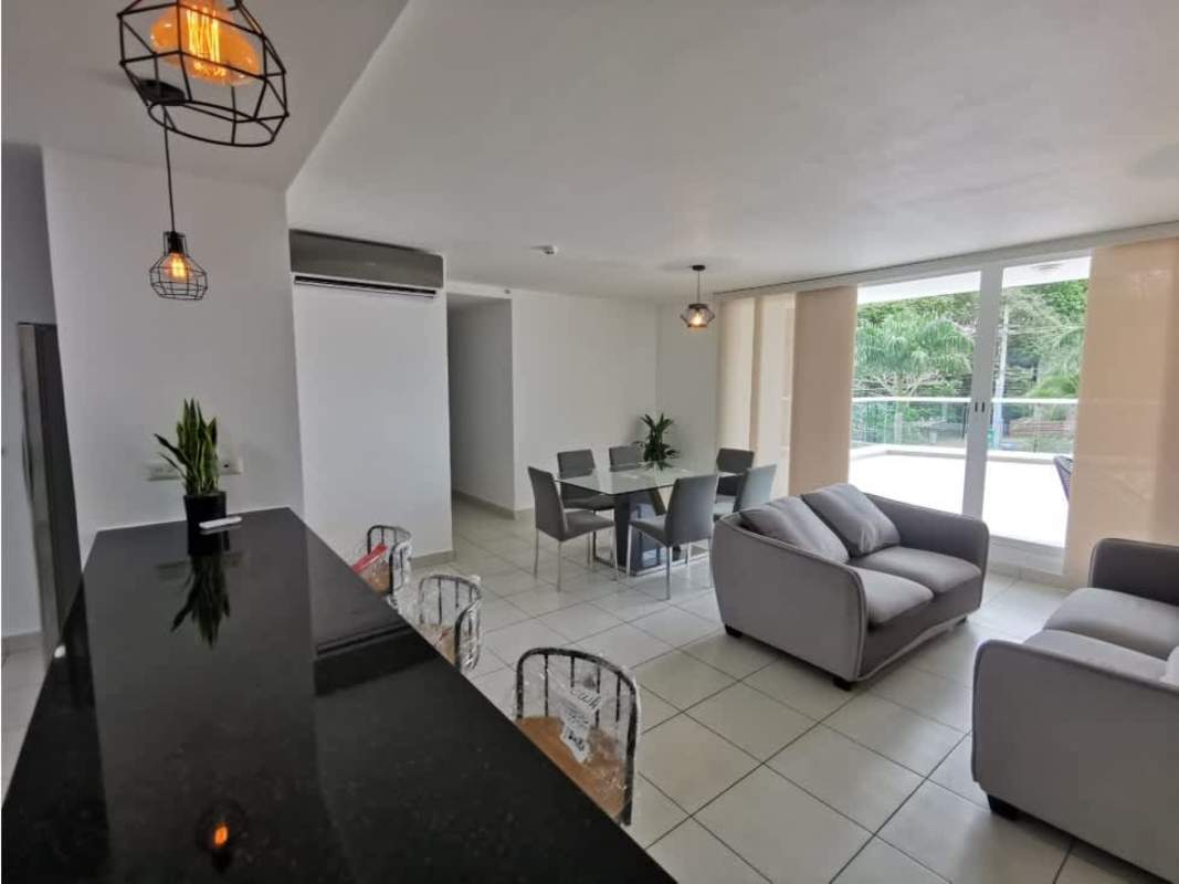 Kitchen with granite countertops, mosaic backsplash, and black island at PH Clayton Park II Clayton Panama