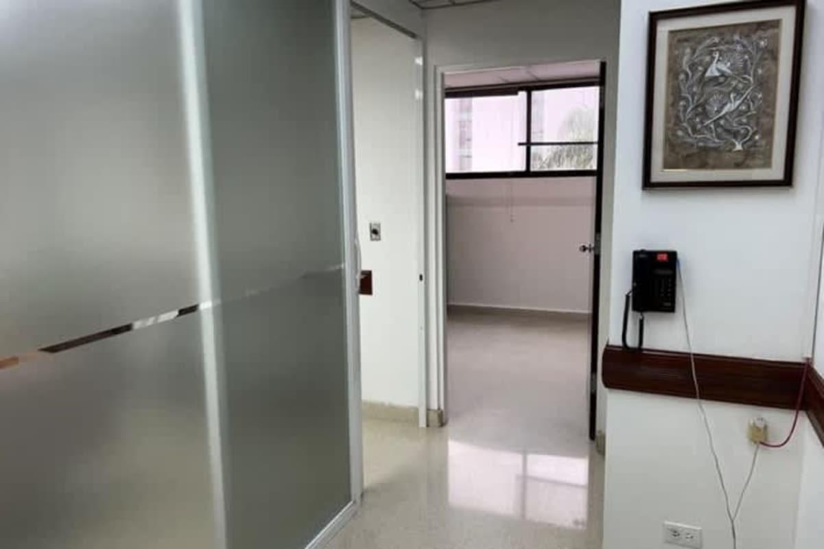 Minimalist hallway corridor with frosted glass door and window consultorios médicos paitilla