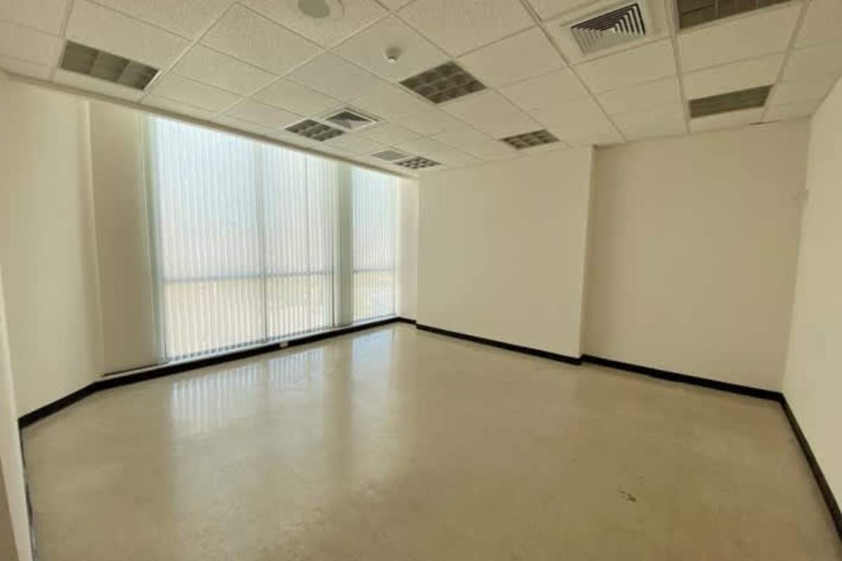 Office bathroom with white tiles modern fixtures PH ADR Obarrio Panama
