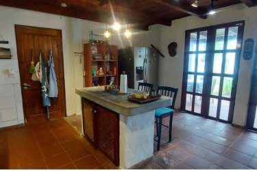 Private oceanfront balcony overlooking tropical garden and Caribbean Sea in Viento Frio estate Panama