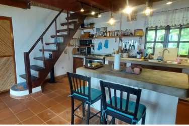 Rustic tropical two-story beach house with balcony and gardens in Colón Panama