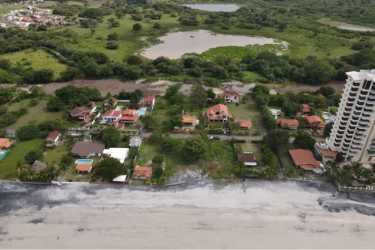Vacant oceanfront land plot with mature trees fence and ocean views in Nueva Gorgona Panama