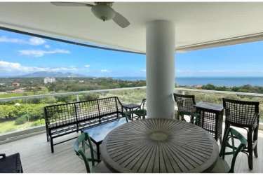 Large terrace overlooking ocean and gardens at Punta Barco Village luxury condo