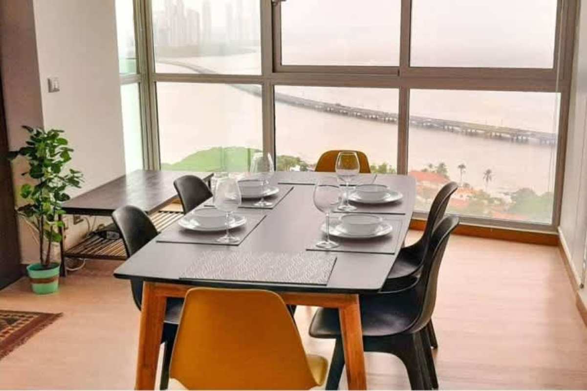 Bright modern living dining with floor-to-ceiling windows ocean and city view Coco del Mar Panama
