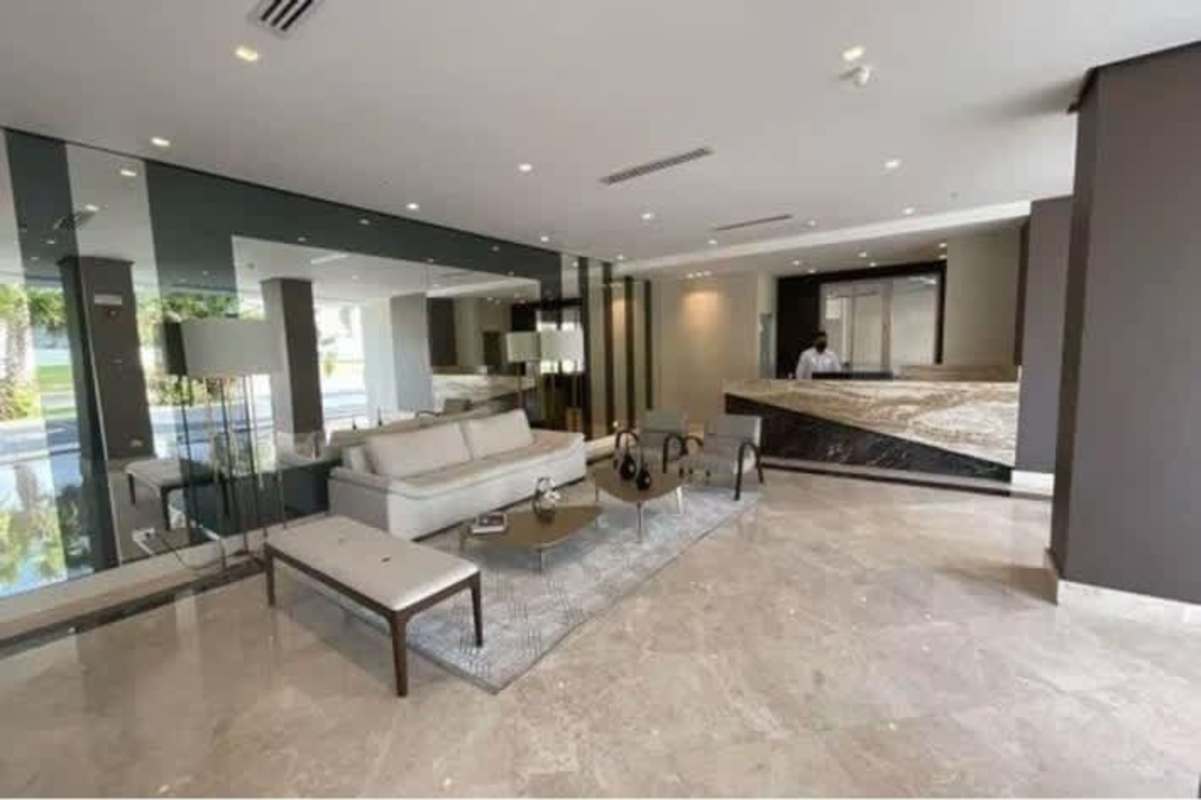 Grand modern lobby with marble floors, seating area at Signature Santa María Panama