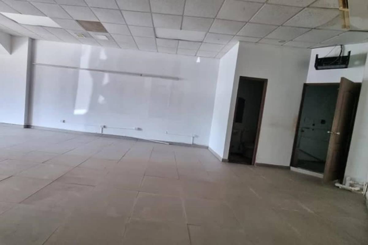 Retail storefront glass facade with parking at Albrook Plaza Ancón Panama City