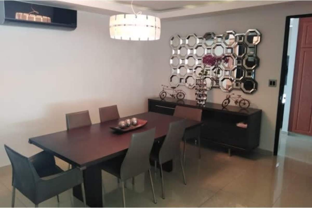 Modern private office with large windows, Red Armchair and blinds overlooking the Pacific Ocean in Ocean Two apartment Panama