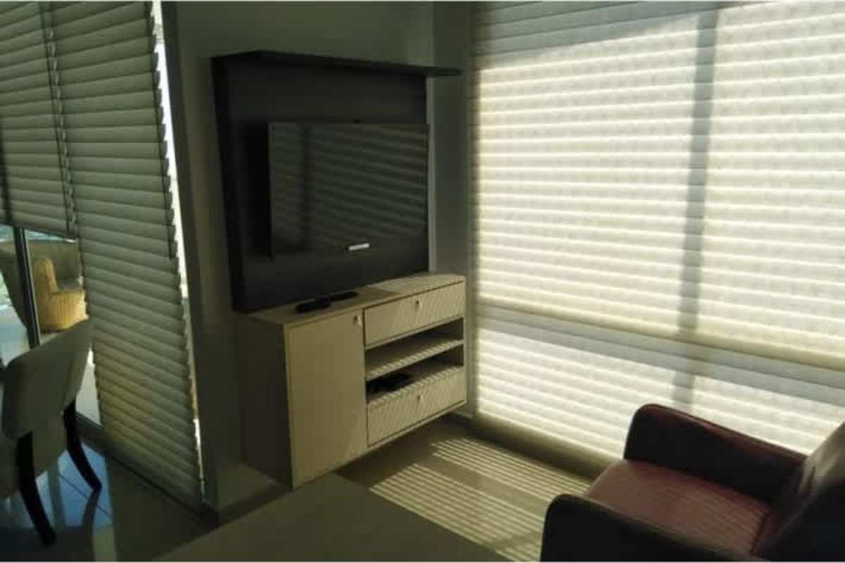 Minimalist living room with wall-mounted TV, large window and sofa in Ocean Two Punta Pacifica apartment