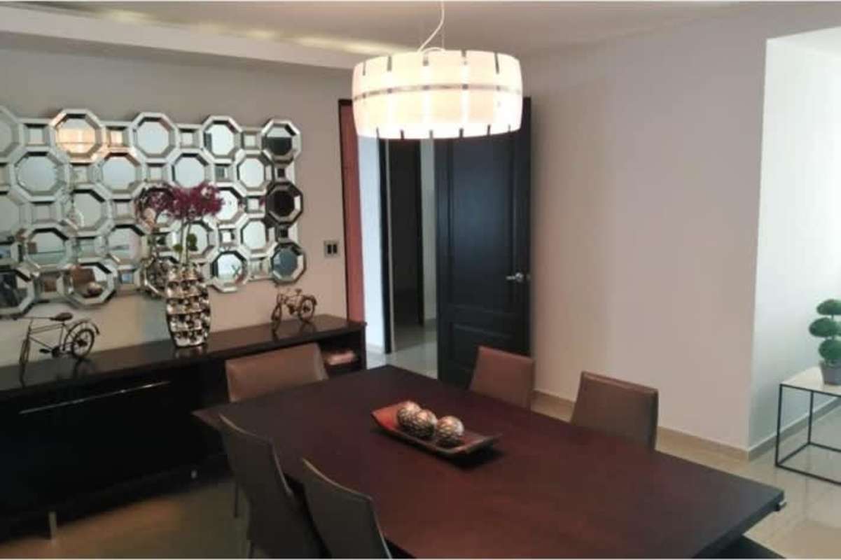 Living room with large sliding doors to balcony, ocean view, couch and entertainment setup in Ocean Two apartment Panama City