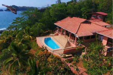 Spacious living room with wood ceilings, large windows, sofas, natural light ocean view Mata Oscura Panama
