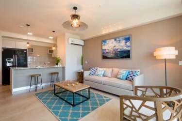 Living room with sliding glass doors ocean view at Royal Palm Playa Gorgona Panama