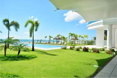 Beachfront garden, pool and palm trees at Royal Palm Playa Gorgona Panama