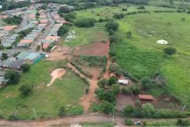 Cleared boundary of development land parcel in Chitré Herrera Panama with fence posts visible