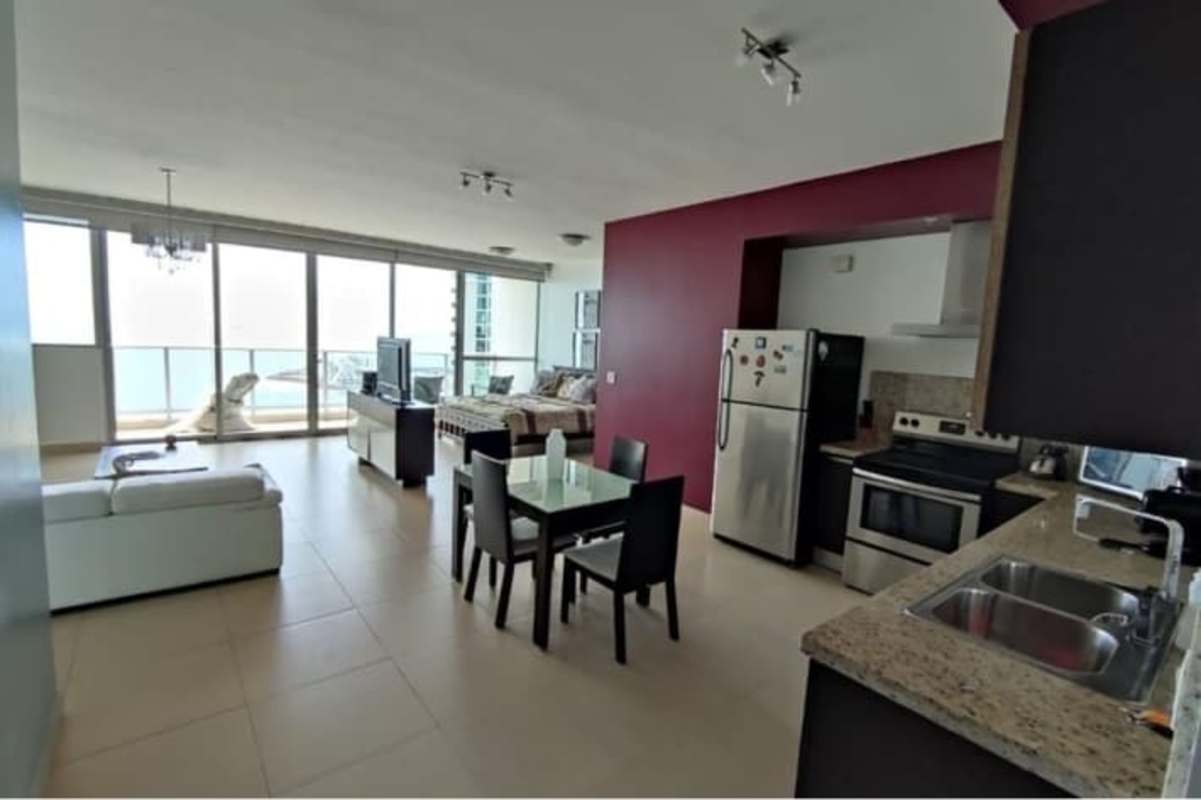 Bright living and dining area with full glass windows and ocean views in Punta Pacifica apartment