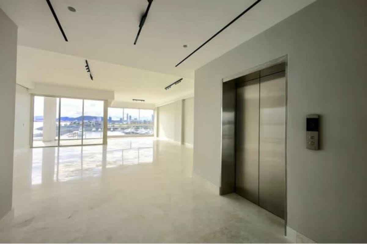 Spacious living room with floor-to-ceiling windows and panoramic ocean views at Waterfront 21 Ocean Reef